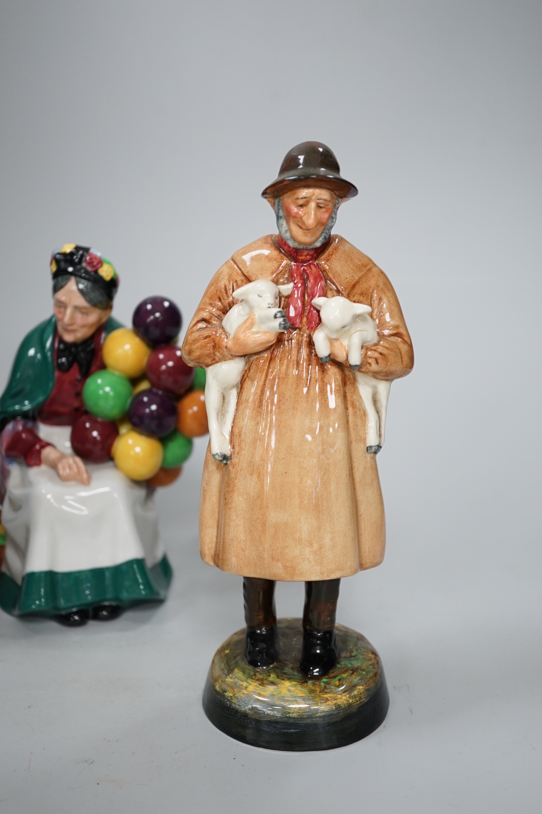Three Royal Doulton figures comprising Lambing Time HN1890 and The Balloon man HN1954, the largest 23cm high